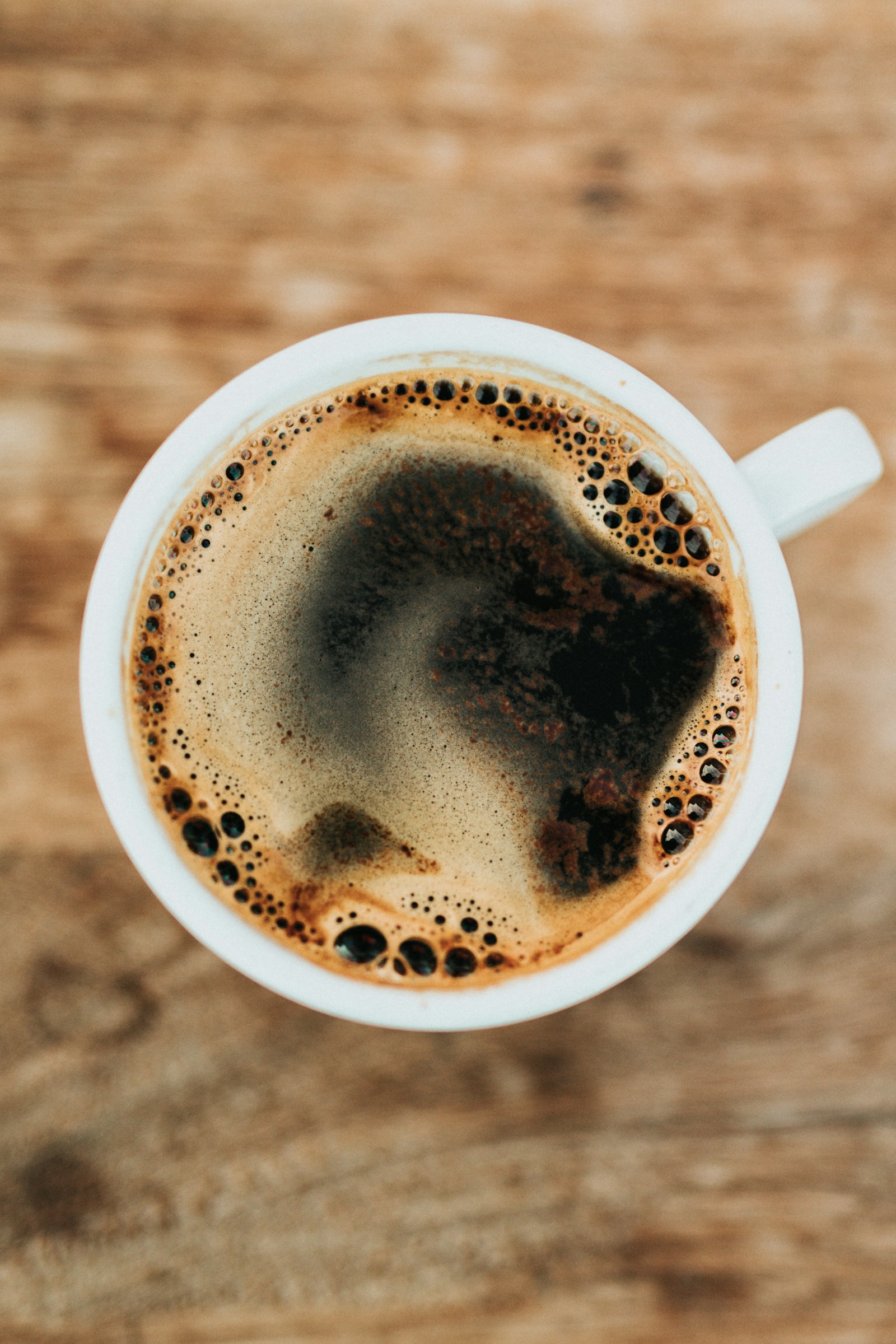 Pour-over coffee brewing through a V60 style dripper into a glass carafe