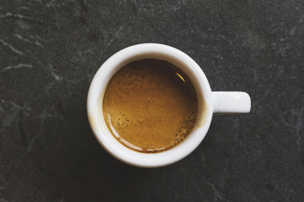 Automatic drip coffee machine brewing a fresh pot of filter coffee on a kitchen counter