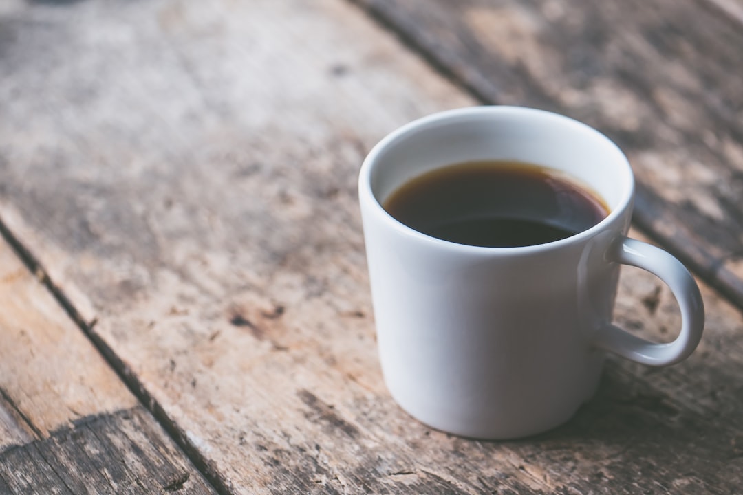 Autumn coffee drinks with pumpkin spice latte and cinnamon on a wooden table