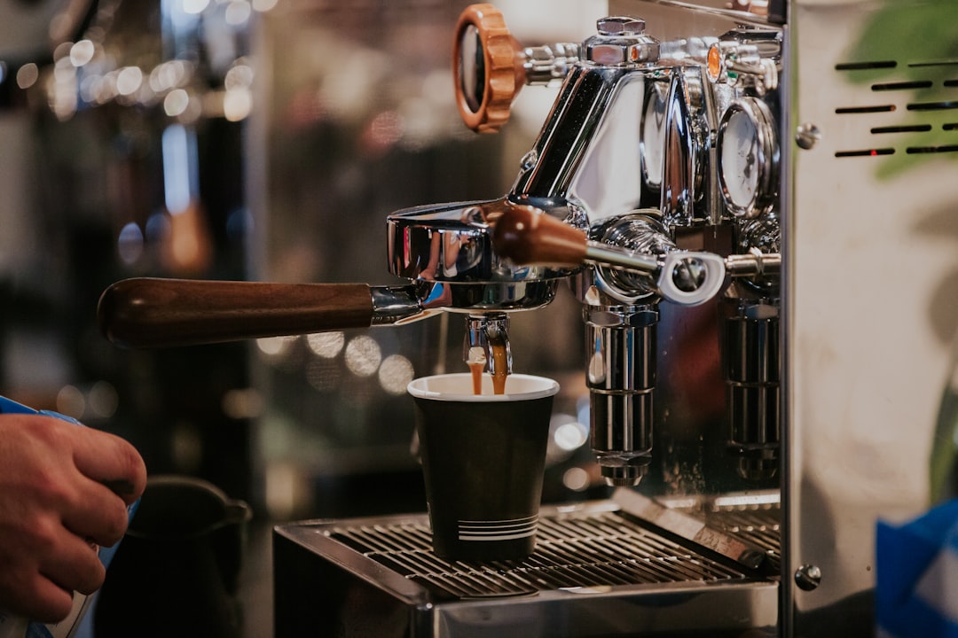 Close-up of fresh espresso beans in a portafilter with crema on a freshly pulled shot