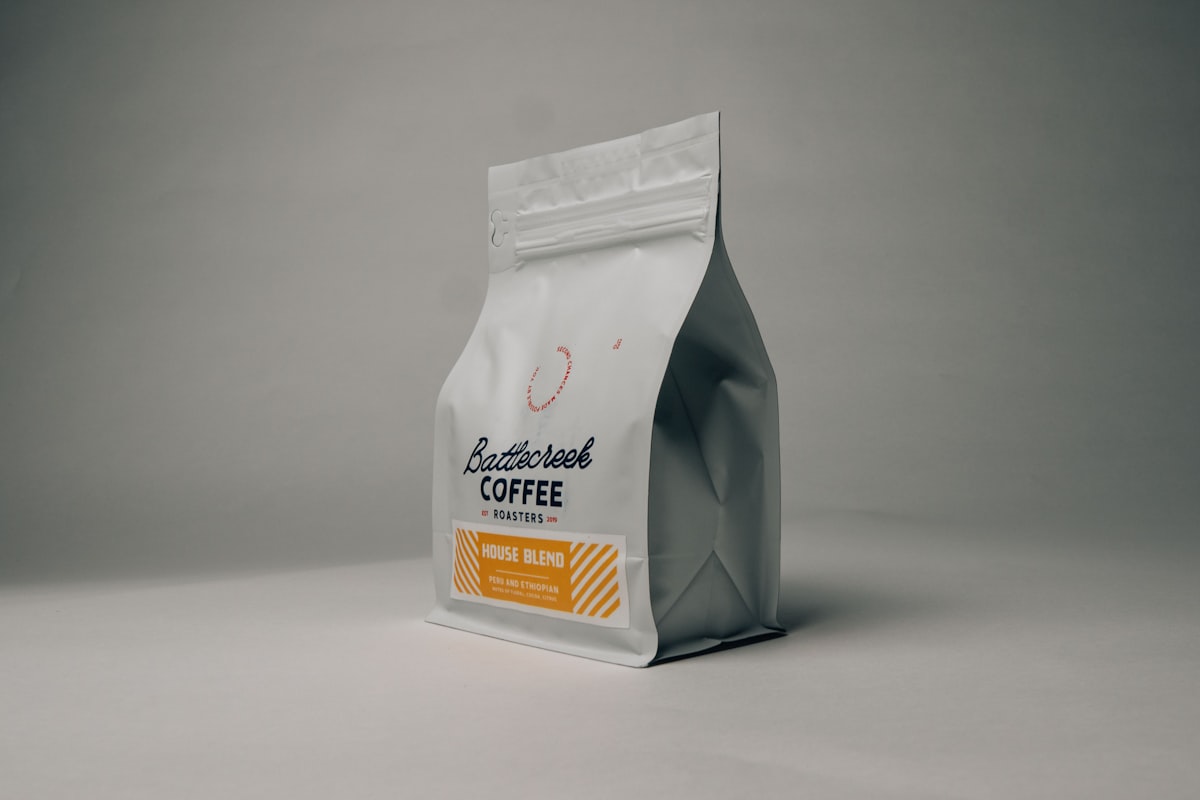 Glass airtight coffee canister with freshly ground coffee on a kitchen counter